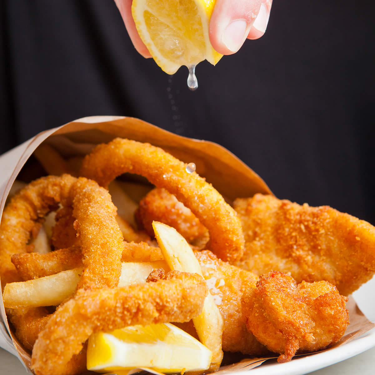 Fish Frenzy (two pieces of crumbed fish, three scallops, three calamari & chips) with lemon.